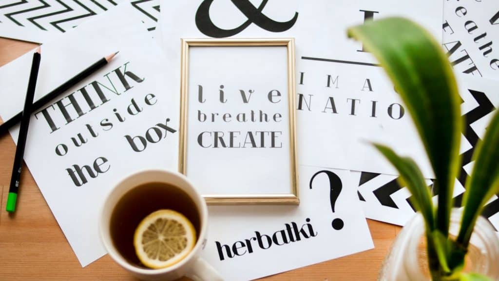 quote calligraphy pages spread out on table