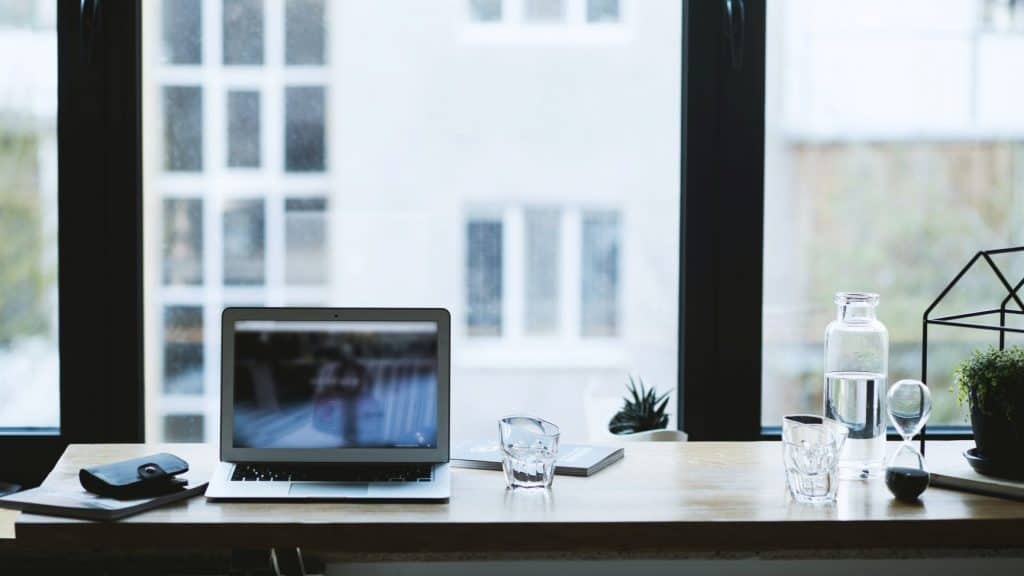silver laptop on table