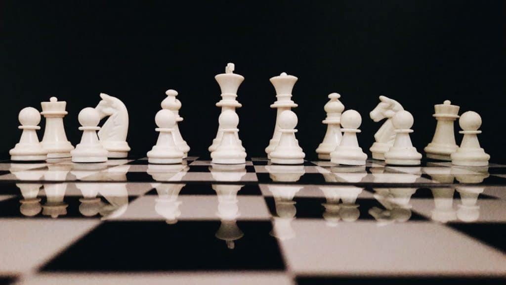 white chess pieces on a chess board