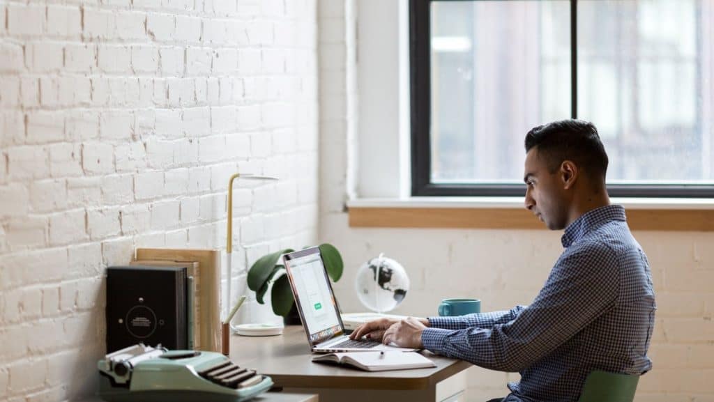 man sitting at laptop working on a brand strategy