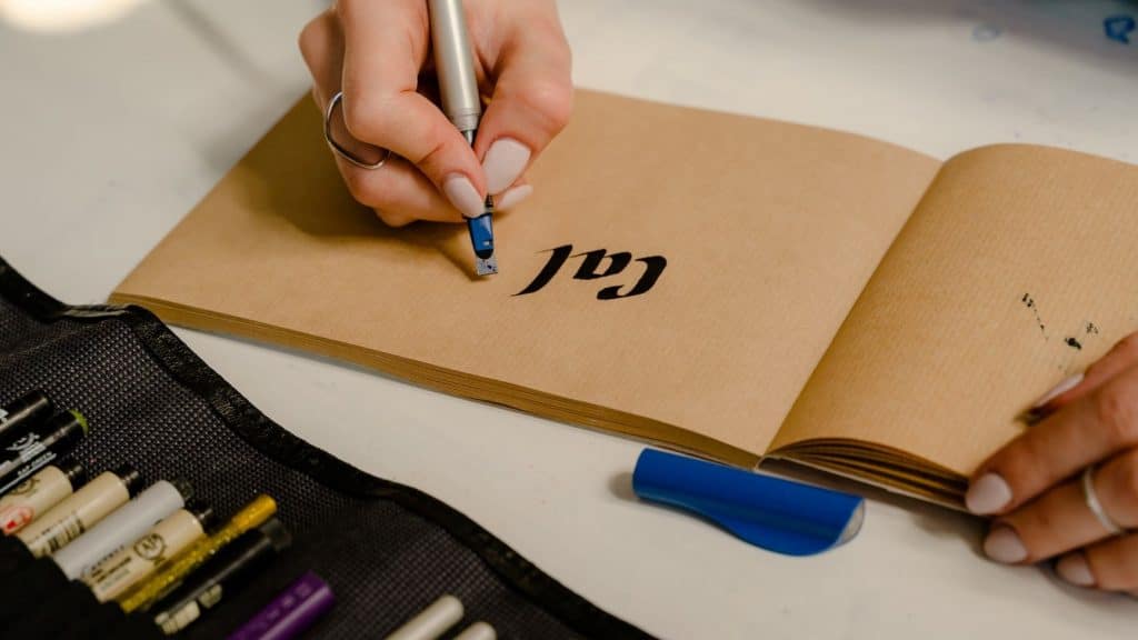 person designing a wellness logo on brown paper