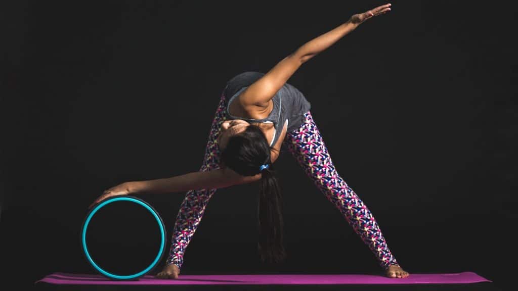 woman doing yoga with a prop