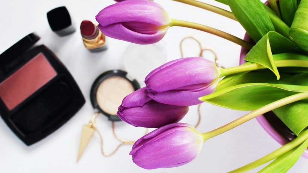 cosmetics and purple tulips