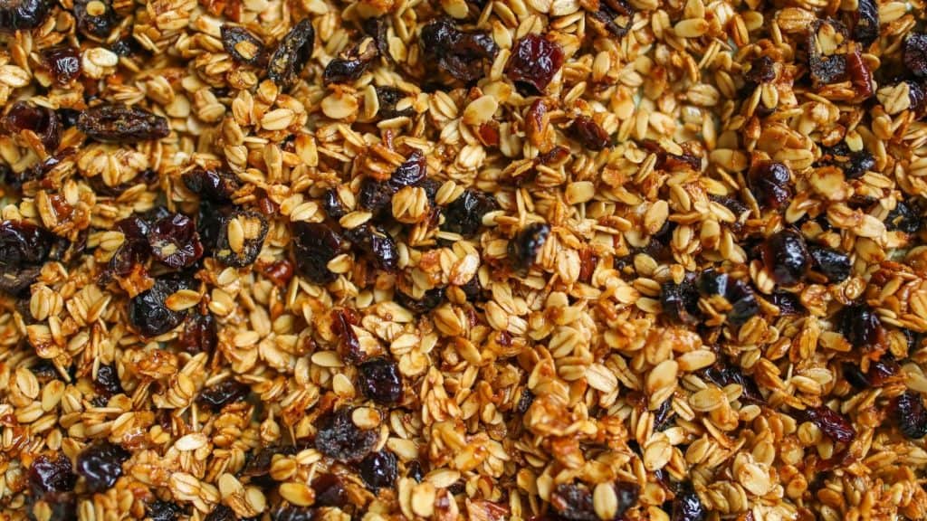 close up photo of granola and berries