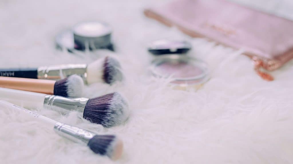 makeup brushes on soft white carpet