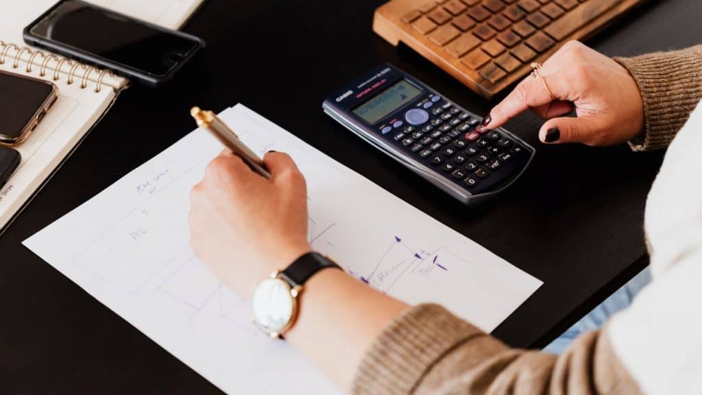 woman making a business plan with a calculator
