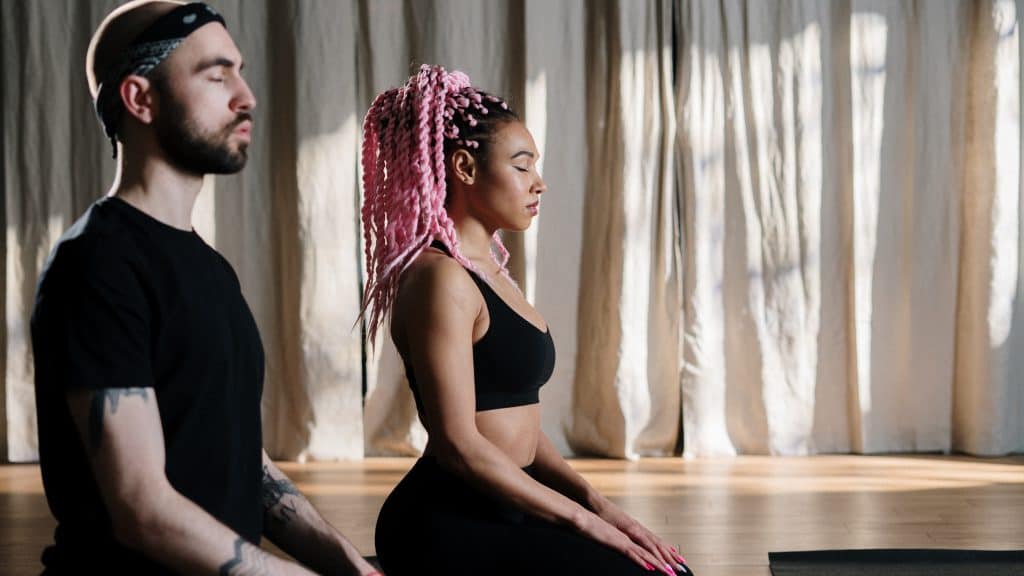 two wellness influencers practicing yoga