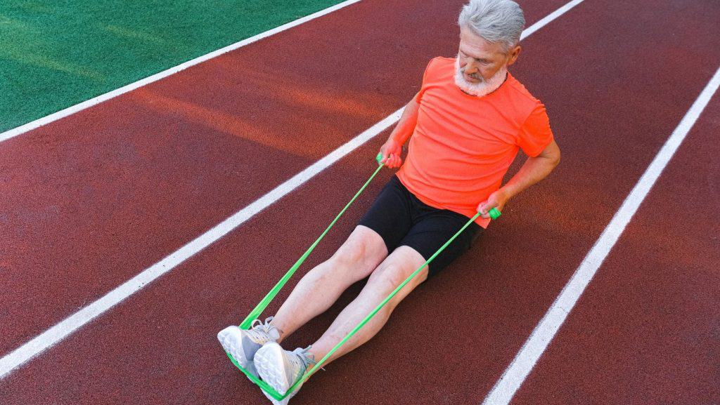 man stretching on a running track