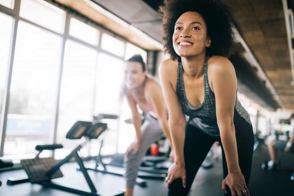 Fit sportswoman exercising and training at fitness club