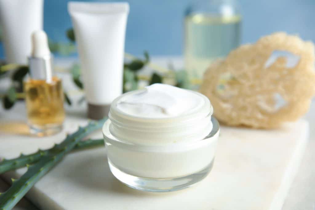 Jar of body care product on table