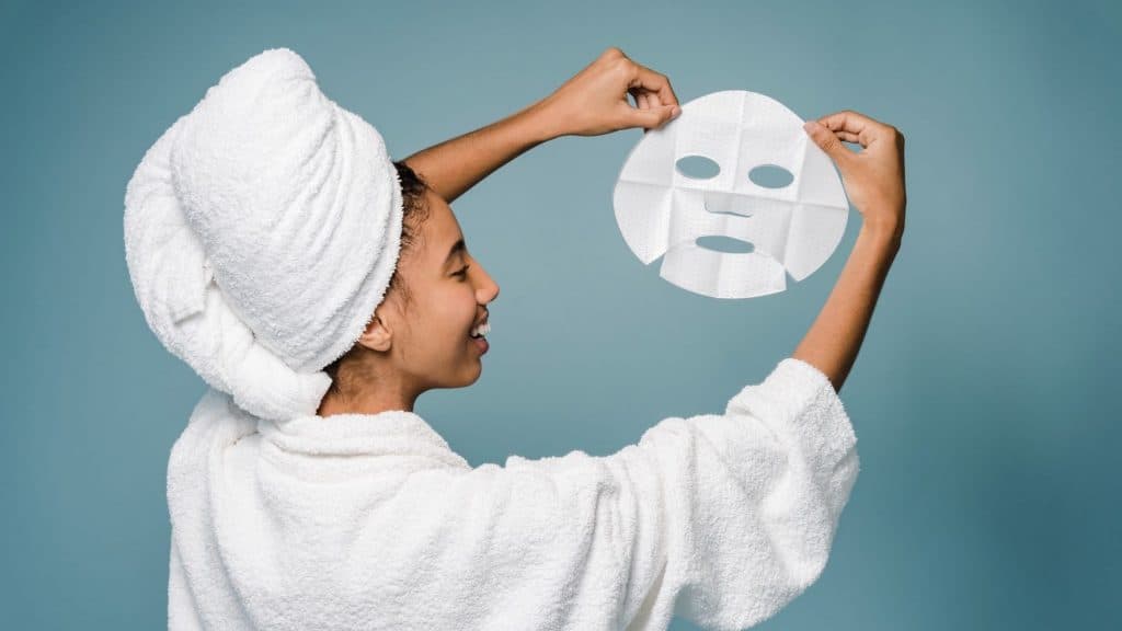 woman holding up a skincare face mask