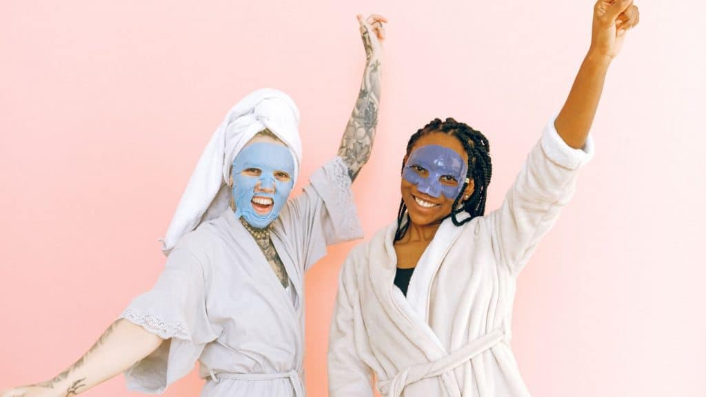 two women wearing skincare face masks