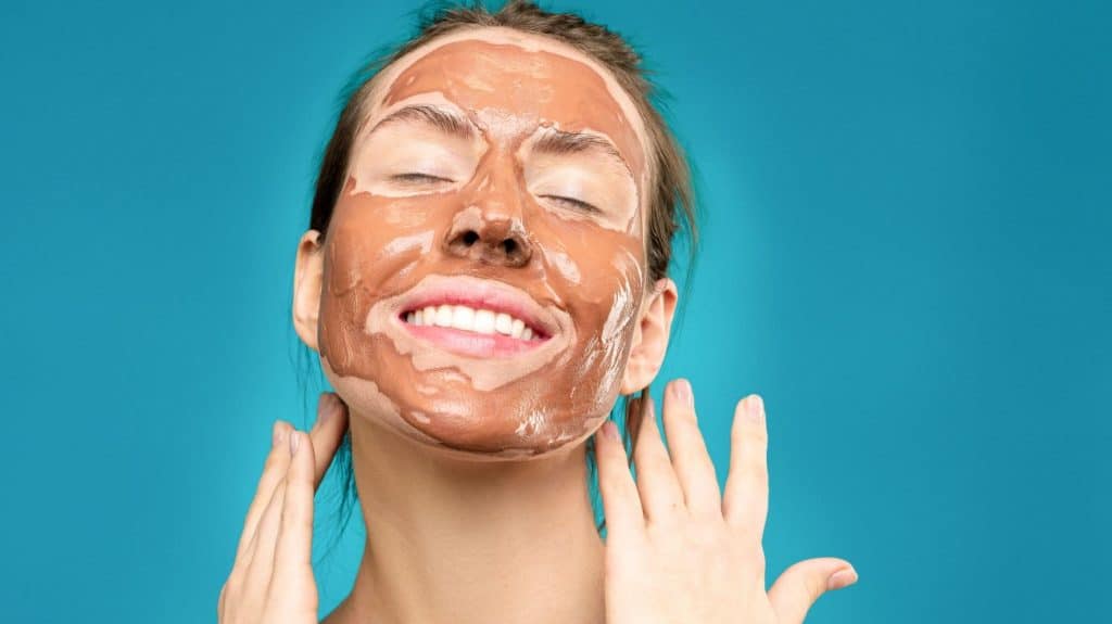 woman wearing a clay skin care mask