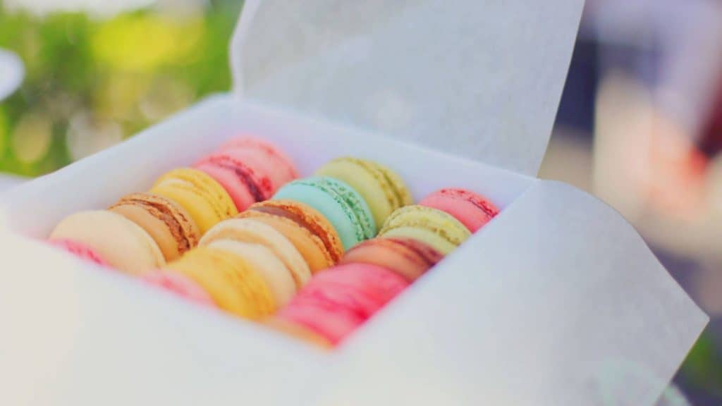 colorful macarons in a white box