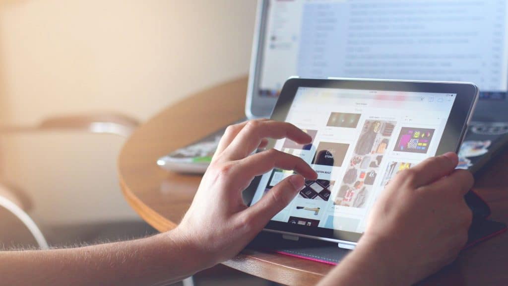 person scrolling through website mood board on a tablet