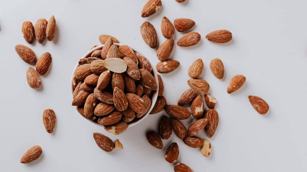 almonds in a bowl on a white table