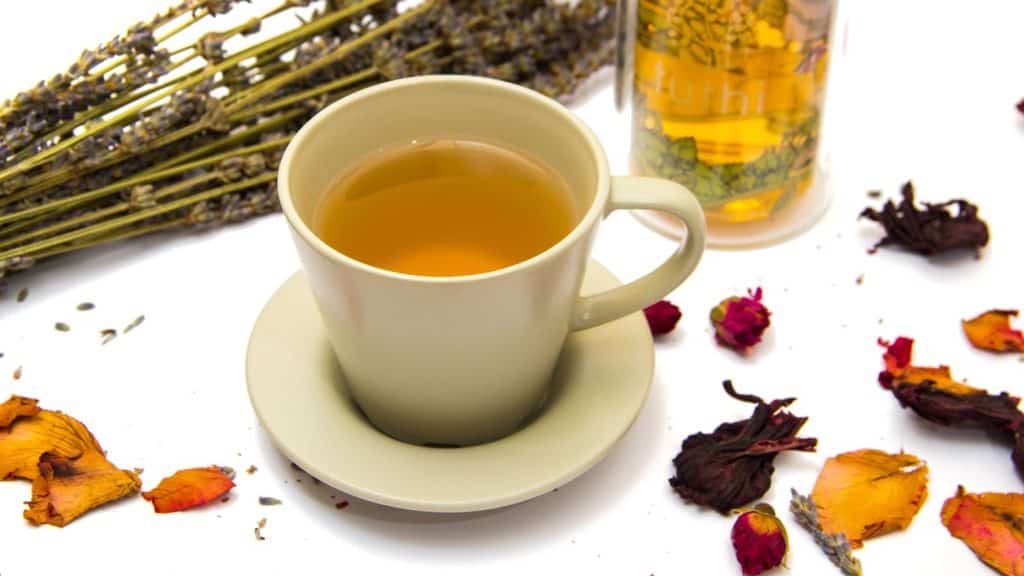 tea cup with tea packaged for sale around it