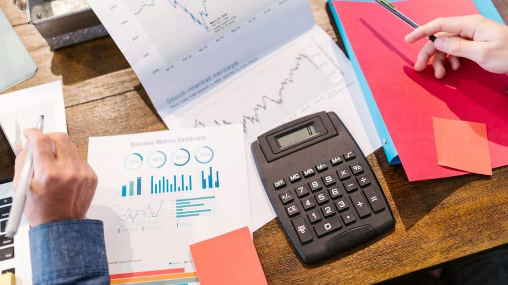 wellness entrepreneur with a calculator and financial files