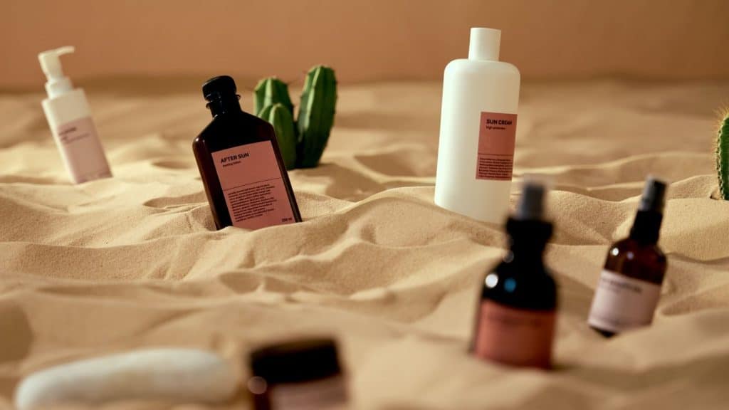 skincare product descriptions on bottles in sand
