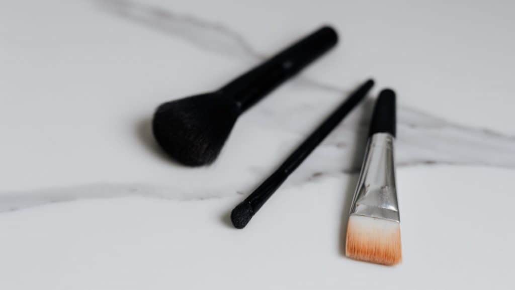 three black makeup brushes