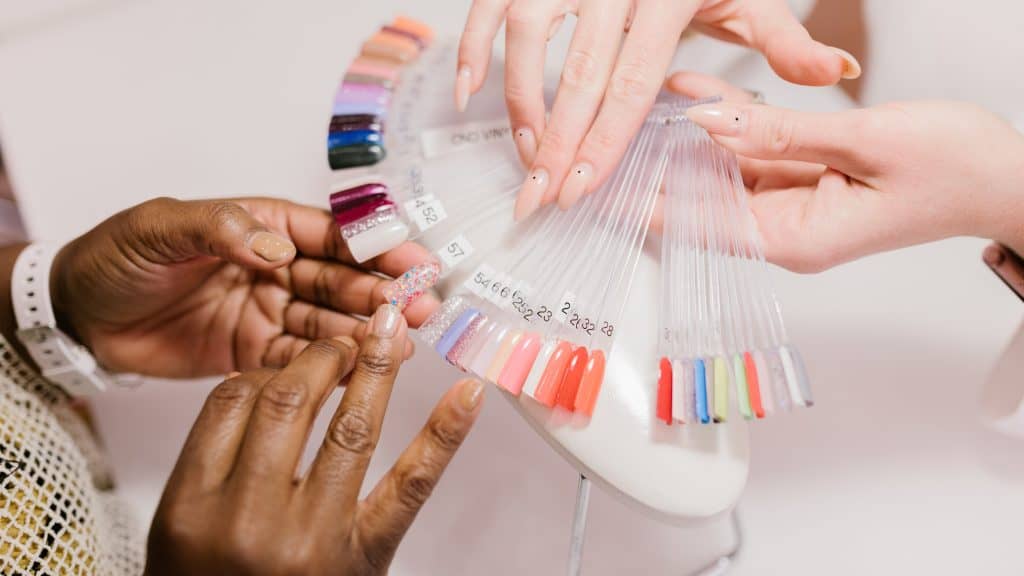 two women holding nail polish branding