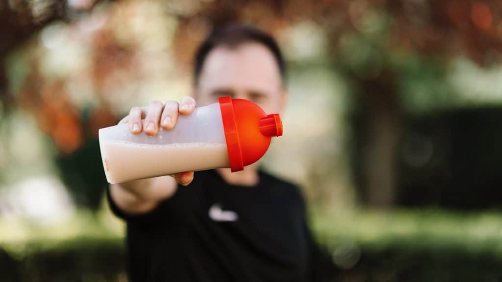 man holding meal replacement shake packaging
