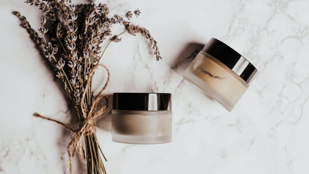 skin care branding of two small containers with lavender leaves next to them