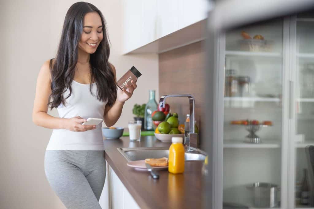 Woman holding dietary supplement