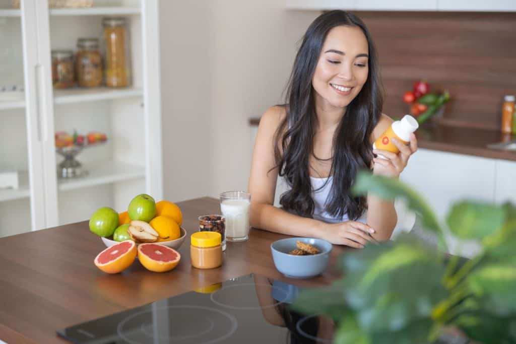 Woman looking at supplement drink label design