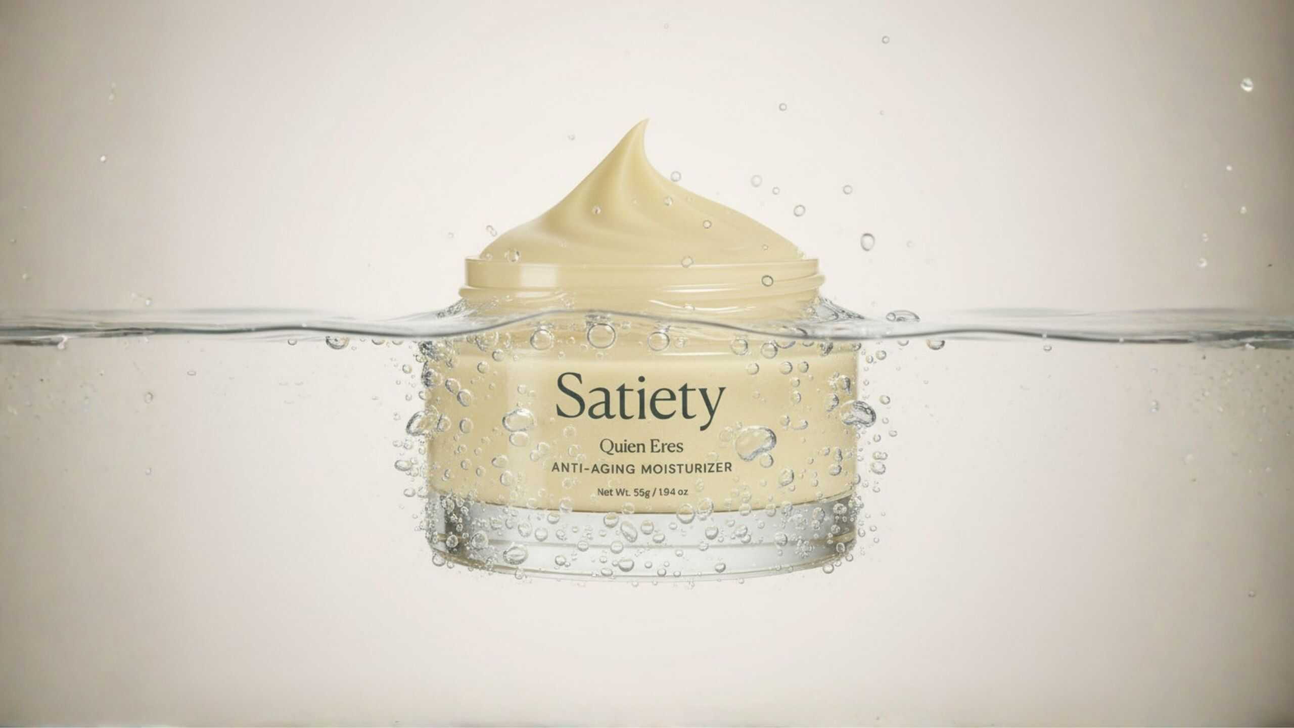 Product photography featuring moisturizer jar submerged in water with air bubbles, highlighting texture, hydration concept, and premium packaging design
