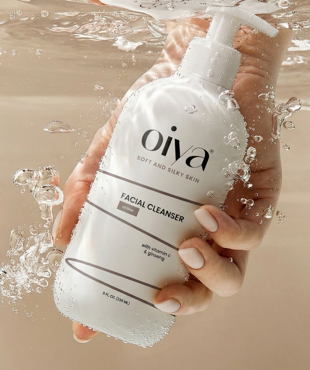 facial cleanser in minimal white packaging held underwater with bubbles, premium skincare product design