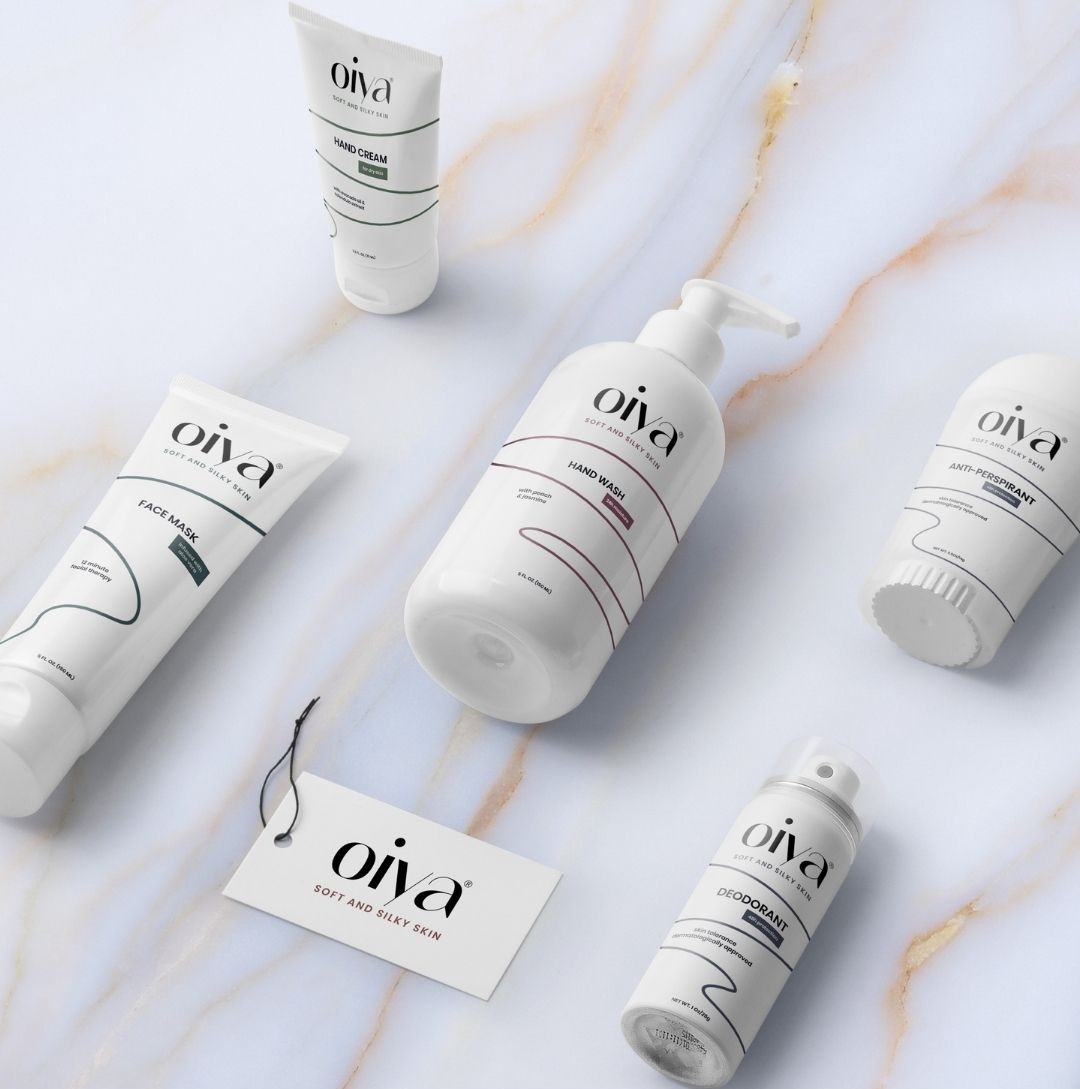 skincare packaging including hand wash, face mask, deodorant and hand cream on marble surface